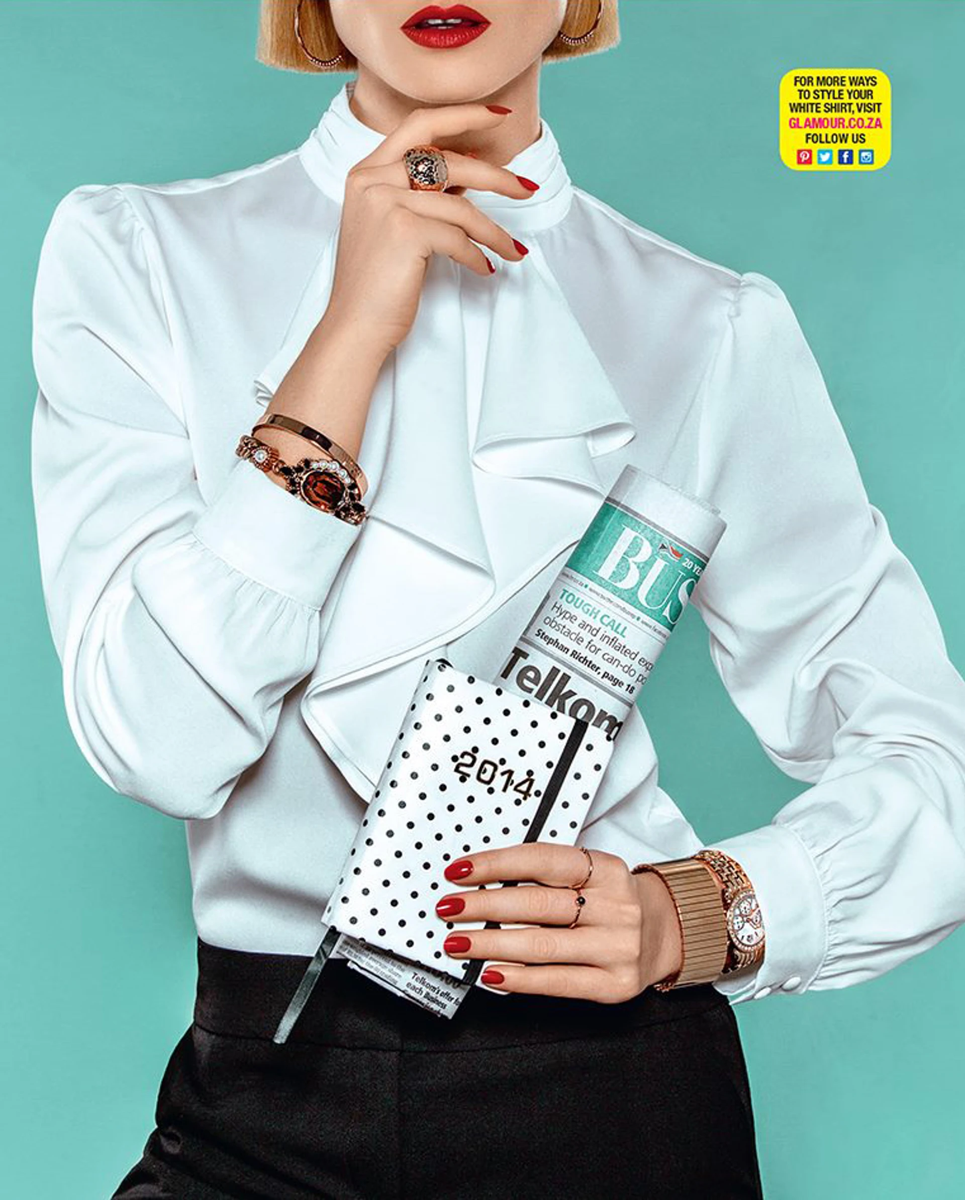 Chic woman in a white high-neck blouse, accessorized with rose gold jewelry, holding a polka-dotted 2014 planner and a magazine, set against a turquoise background.